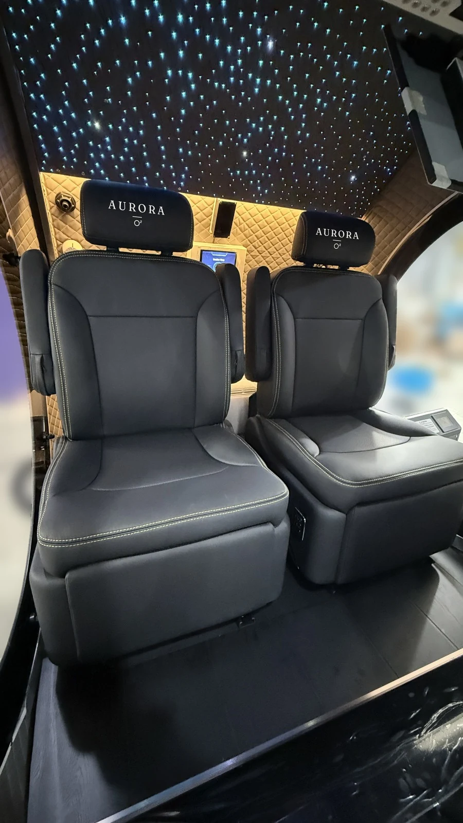 The Aurora cabin with two seats, the Aurora name embroidered on each headrest