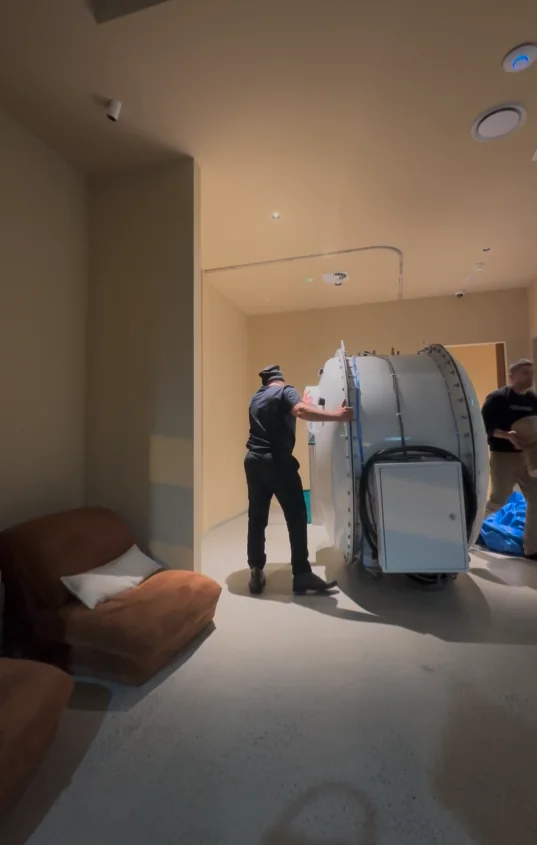 Our team moving a chamber into position during a home install