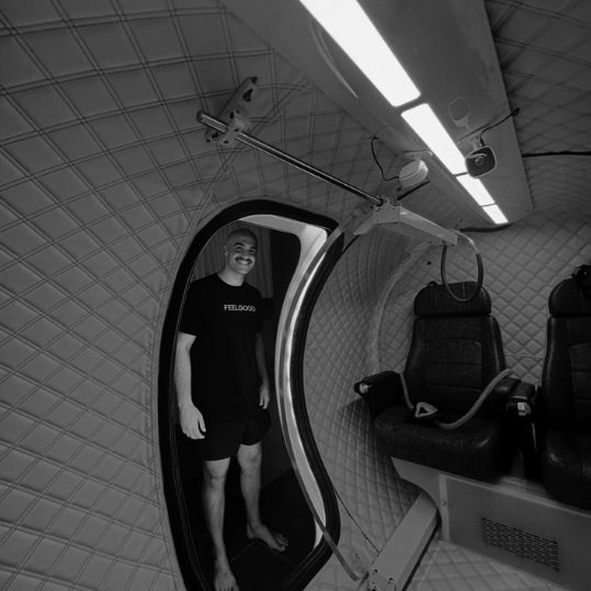 Pete Frost, founder of Hyperbaric HQ, in the doorway of a hyperbaric chamber.
